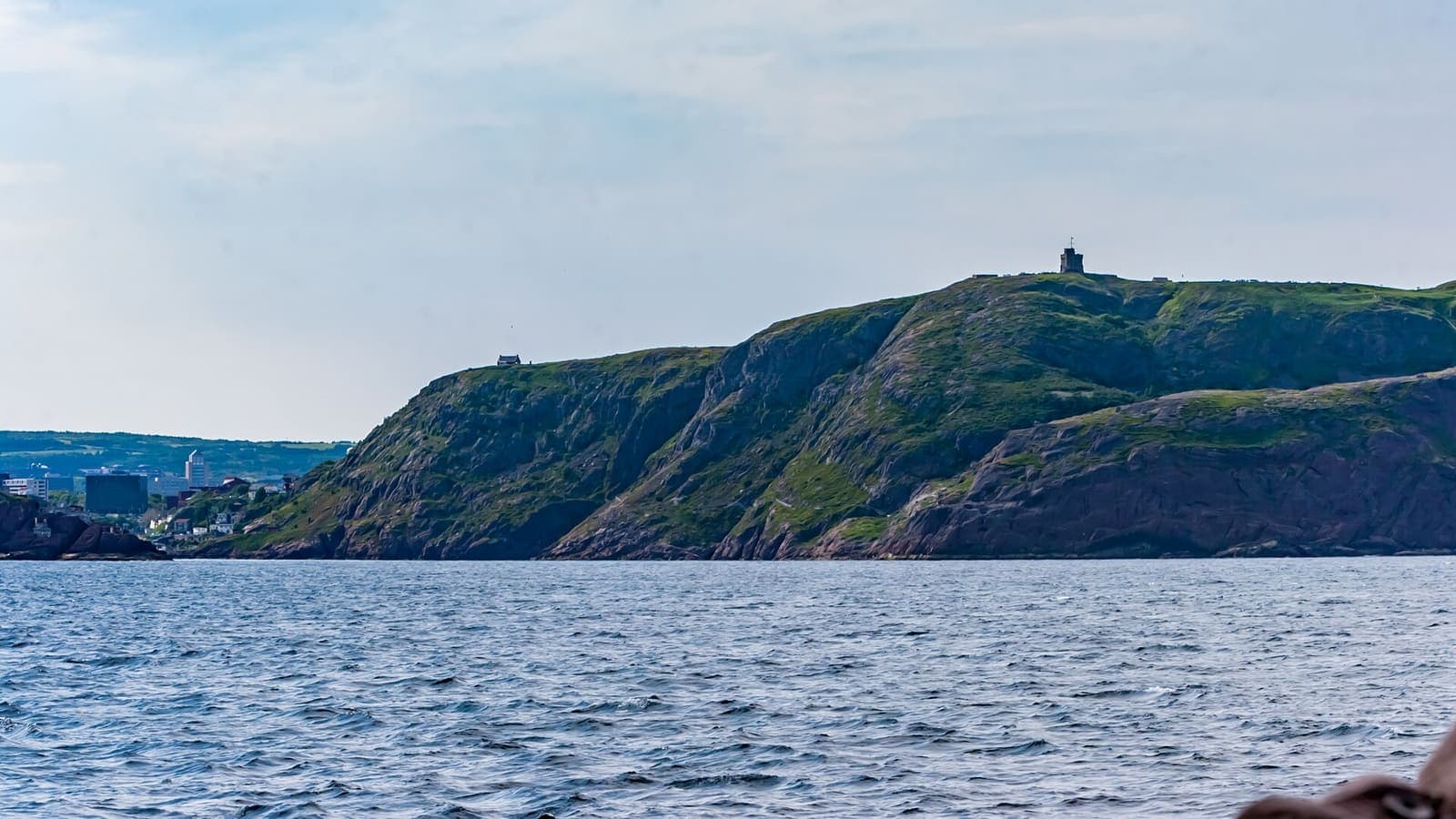 Signal Hill and Cabot Tower seen from the sea near St. John's, Newfoundland and Labrador